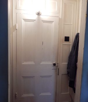 In Simon Truby's former front door, glass sidelights have been replaced by white-painted wood.
